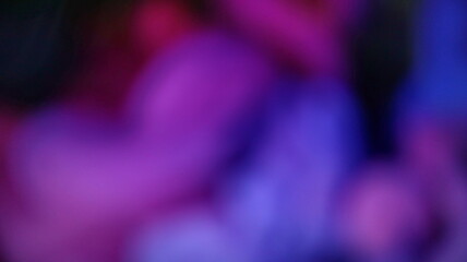 Abstract blurred lights create a vibrant and colorful display of pink, purple, and blue hues, evoking a dreamy and ethereal atmosphere.