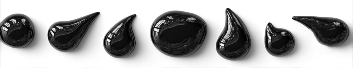 Black paint or ink droplets arranged on a white background