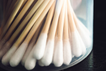 Close-up of cotton swabs in a transparent container, set against a dark background in Bengaluru,...