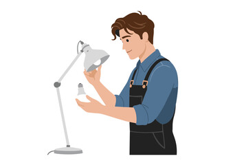 Young Man in Blue Shirt and Black Overalls Replacing Light Bulb in Desk Lamp.