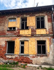 Abandoned building facade with boarded windows