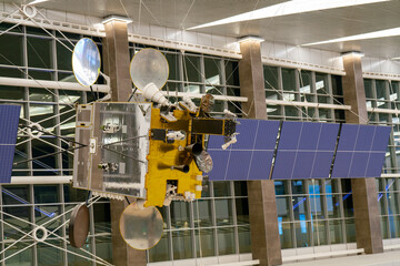 A model of a space satellite with solar panels.