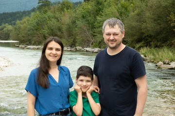 Fototapeta premium Happy family mom, dad and child walking in nature