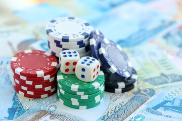 Bahraini dinar currency money bills and casino chips with dice. The concept of gambling and casino