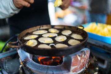 Khanom Khai in hot pan make by Thai trader, Khanom Khai is a Thai oval sweetmeat made with egg and sugar