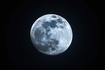 Fototapeta premium Full moon in a dark night sky, showing craters and subtle color variations