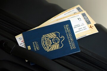 United Arab Emirates passport and avia tickets on travel bag close up. The concept of travel and...