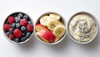 Three small bowls, each holding a different healthy breakfast component, arranged horizontally on a white background.  A bowl of frozen raspberries and blueberries, 