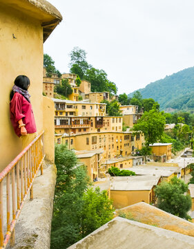 Tourist woman stand enjoy scenic Masuleh village panorama in north east Iran - popular famous tourism destination in persia