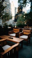 Fototapeta premium A stylish outdoor seating area with wooden furniture and city views, bathed in soft evening light.