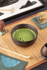 Japanese matcha green tea in a bowl on a bamboo mat.