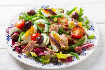 Mediterranean Tuna Salad. Nicoise Salad. White wooden background
