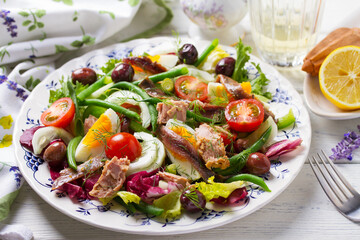 Mediterranean Tuna Salad. Nicoise Salad. White wooden background