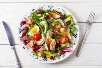Mediterranean Tuna Salad. Nicoise Salad. White wooden background. High angle view