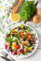 Mediterranean Tuna Salad. Nicoise Salad. White wooden background. High angle view