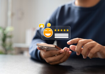 Customer giving 5-star rating on smartphone screen with smiley emoji icon, symbolizing excellent user feedback, satisfaction review, and positive digital reputation.