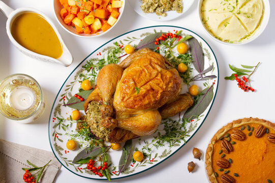 Celebration of Thanksgiving Day. Roasted chicken or turkey, mashed potatoes, vegetables and pumpkin pie. View from above, top studio shot