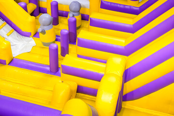 Inflatable jumping castle or bounce house with colorful slide and playground equipment inside of department store, high angle view with copy space