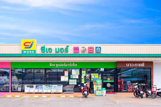 Samut Sakhon, Thailand - September 24, 2025 : Large CJ more supermarket with customer service parking lot area in front of convenience store against blue sky background, Front view