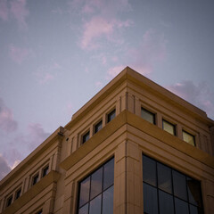corner of stately building against a sunset sky