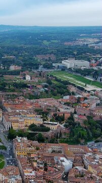 Vertical 4K drone video Rome's Circus Maximus ancient racing track park surrounded by historic cityscape. Epic aerial footage of Roman Empire's largest stadium site for mobile video social platforms.