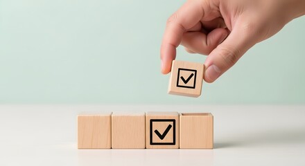Hand placing a wooden block with a checkmark into a row of blocks, symbolizing completion and success