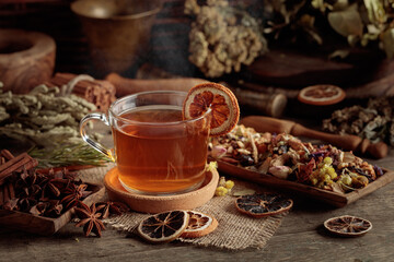Tea with ingredients and slices of dried oranges.