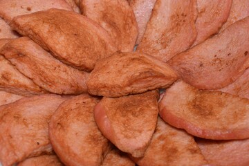 Close-up of sliced ​​pieces of fried sausage. Food background
