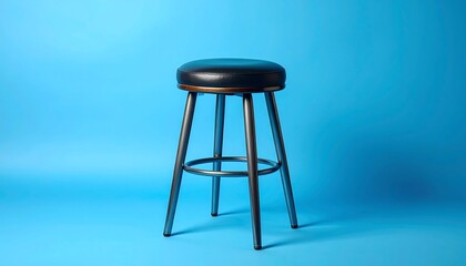 Black leather bar stool against bright blue backdrop