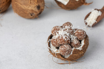 Homemade vegan healthy candies with sugar-free coconut chips, made from dried fruits and nuts 