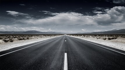 Naklejka premium Long highway stretching across desert landscape with car driving toward horizon under dramatic sky