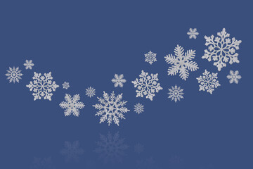 Christmas blue background of silver snowflakes flying in the air with copy space. Holiday card for New Year and Christmas