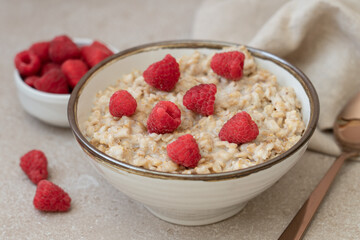 Bowl of Oatmeal Porridge with Fresh Raspberries. Healthy Breakfast Concept