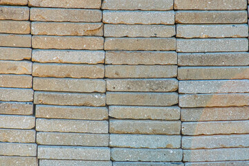 Close-up view of a herringbone brick wall in an ancient Central European village, with variations in color and texture No people or text present natural lighting