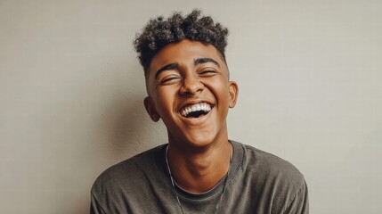 Obraz premium A young man laughs with pure joy, showcasing a genuine and happy smile.