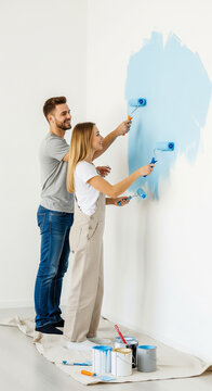 Couple painting a room blue