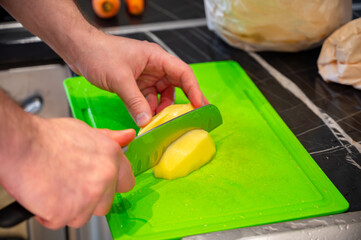 Slicing Potatoes on Plastic Cutting Board