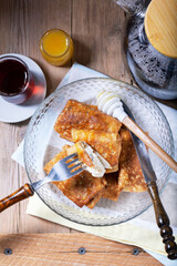 Pancakes with cottage cheese and raisin filling, served with honey and black tea. Traditional treat for Maslenitsa or Carnival.