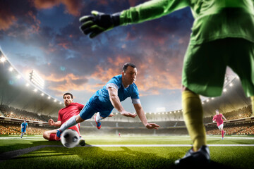 Sports concept. Professional soccer players in action. Tackling the ball. Soccer championship. Sunset on stadium. Soccer. Soccer arena full of fans