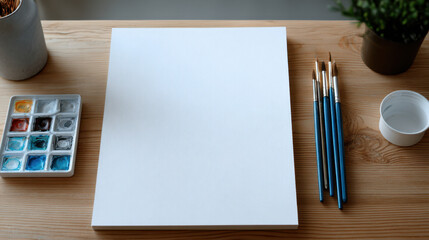 Minimal workspace setup.Minimal workspace setup with blank canvas and paintbrushes on wooden table ready for creative painting session
