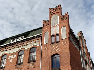 Historic red brick fire station facade in Kaliningrad, German architectural style, against blue sky...