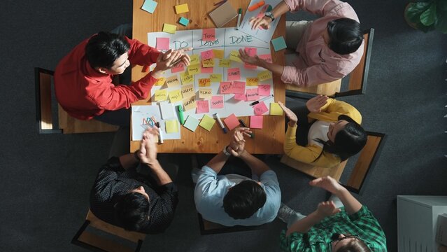 Time lapse of people writing and making scrum task board while writing marketing and planning strategy at colorful sticky notes. Smart team manage work performance by using kanaban board. Convocation.