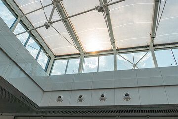 Fototapeta premium Spacious interior with multiple skylights, translucent glass panels, light walls, and even illumination Empty room, minimalistic design, potentially for various functions such as exhibition hall or