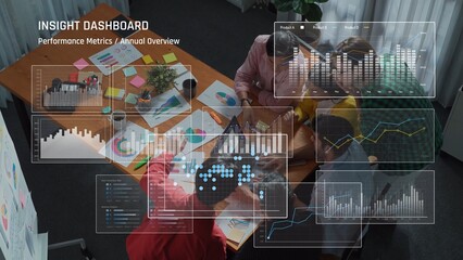 A business team engaged in collaborative analysis of performance metrics using an insight dashboard filled with colorful charts and graphs in a modern office setting. Raster