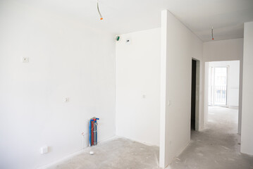 An empty apartment without renovations or furniture, just white walls