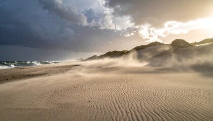 Dramatic coastal dunes at sunset with storm clouds