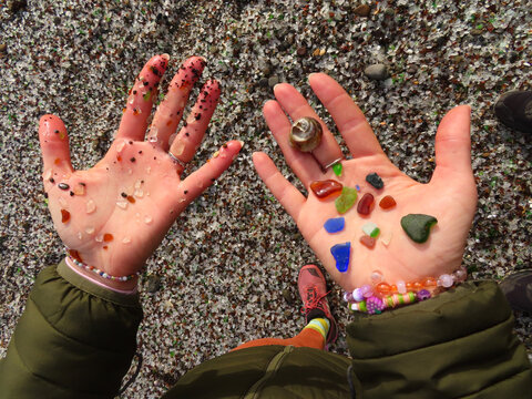 Woman's Hands Collecting Glass Pebbles