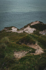 Scenic coastal view overlooking the waves and cliffs during the early evening light