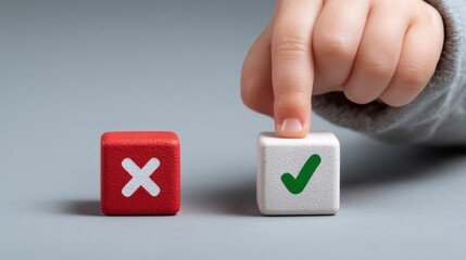 Child's hand choosing a green check mark block over a red x block.