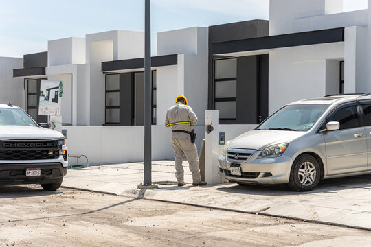 Federal Electricity Commission (CFE) worker installing an electricity consumption meter.  Guadalajara, Jalisco, Mexico, Oct 1, 2024.